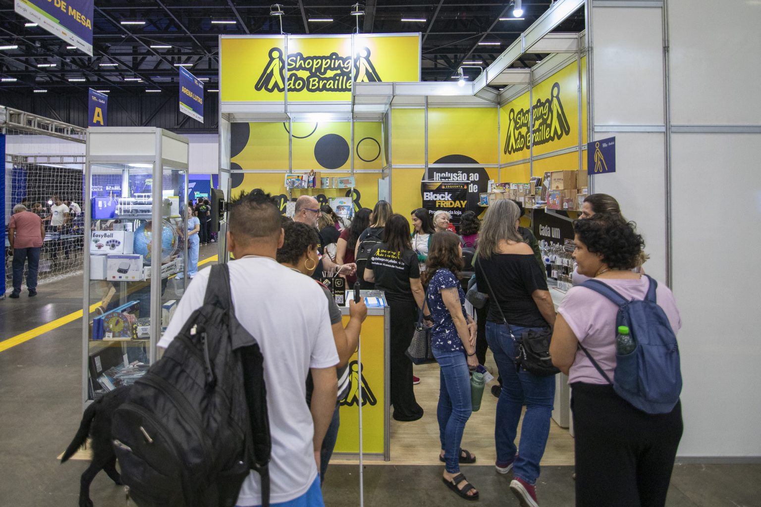 Estande Shopping do Braille na feira Reatech com público explorando produtos acessíveis